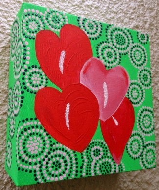 image of a painted green box with 4 red hearts