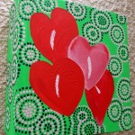 image of a painted green box with 4 red hearts