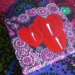 image of a painted purple box with three red hearts