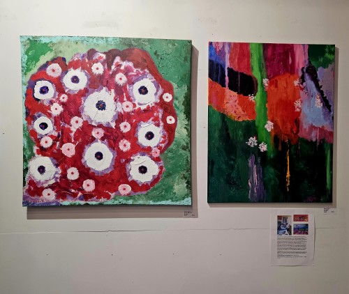 Frank Oliva standing next two his Aboriginal style art at Arts at Marks Garage in august 2024