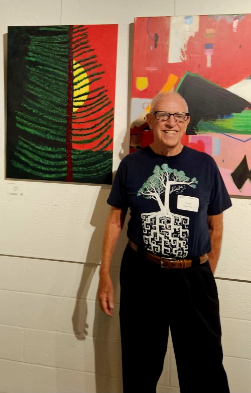 Frank Oliva standing at Pamana Art Exhibit October 2025