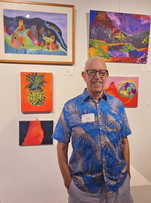 Frank Oliva standing next two work at the Annual Member Show in October 2025