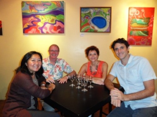 4 friends at a table in Oeneo Winemaking in Kailua, Hawaii